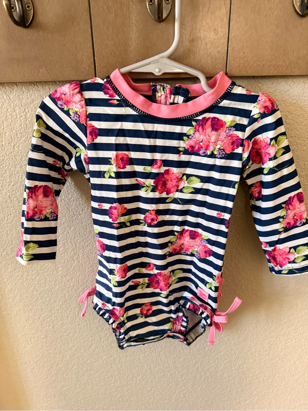 Ruffle Butts Navy & White Stripe Rash Guard with Pink Trim and Floral Accents